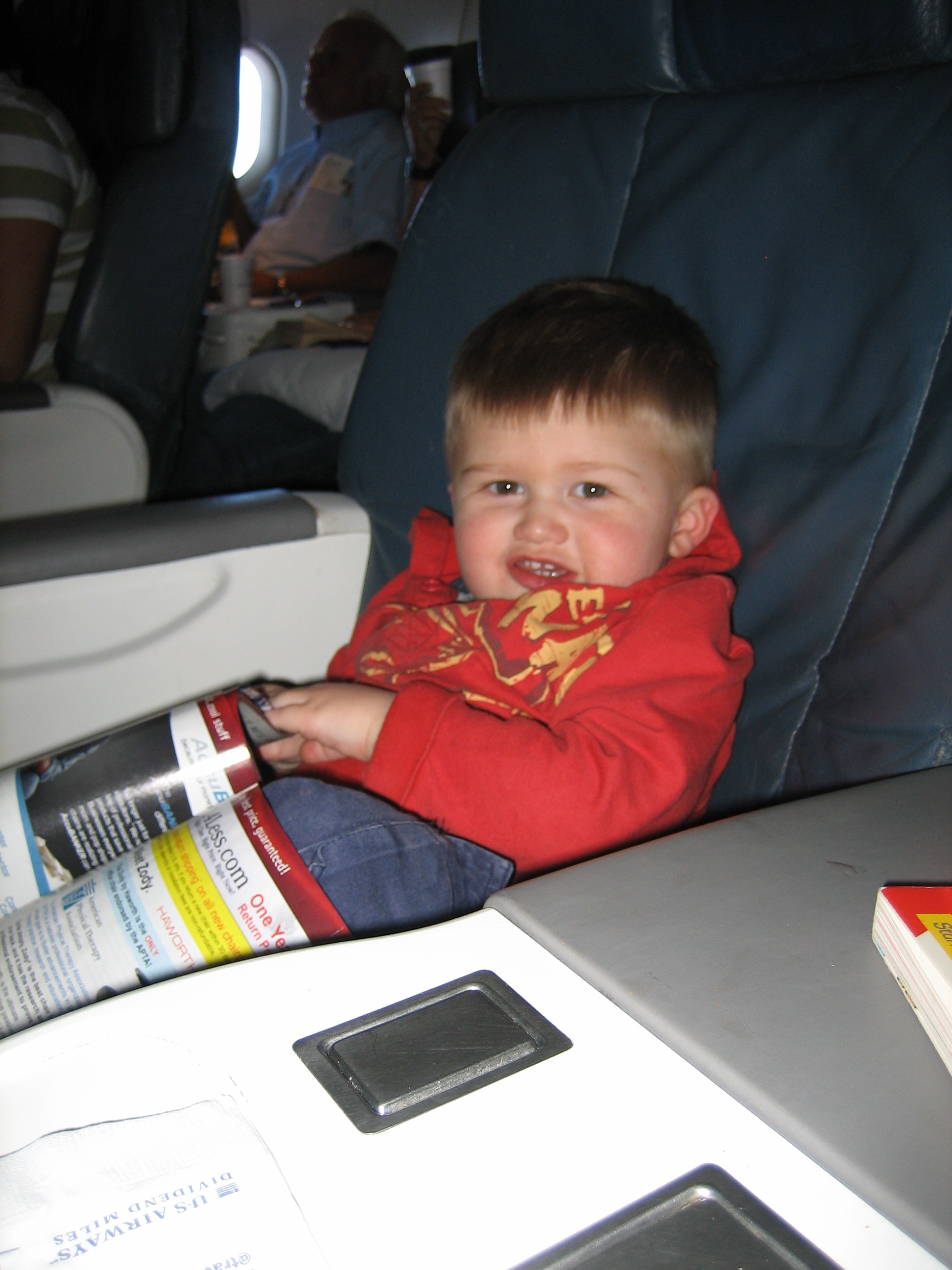 small child in a business class airline seat