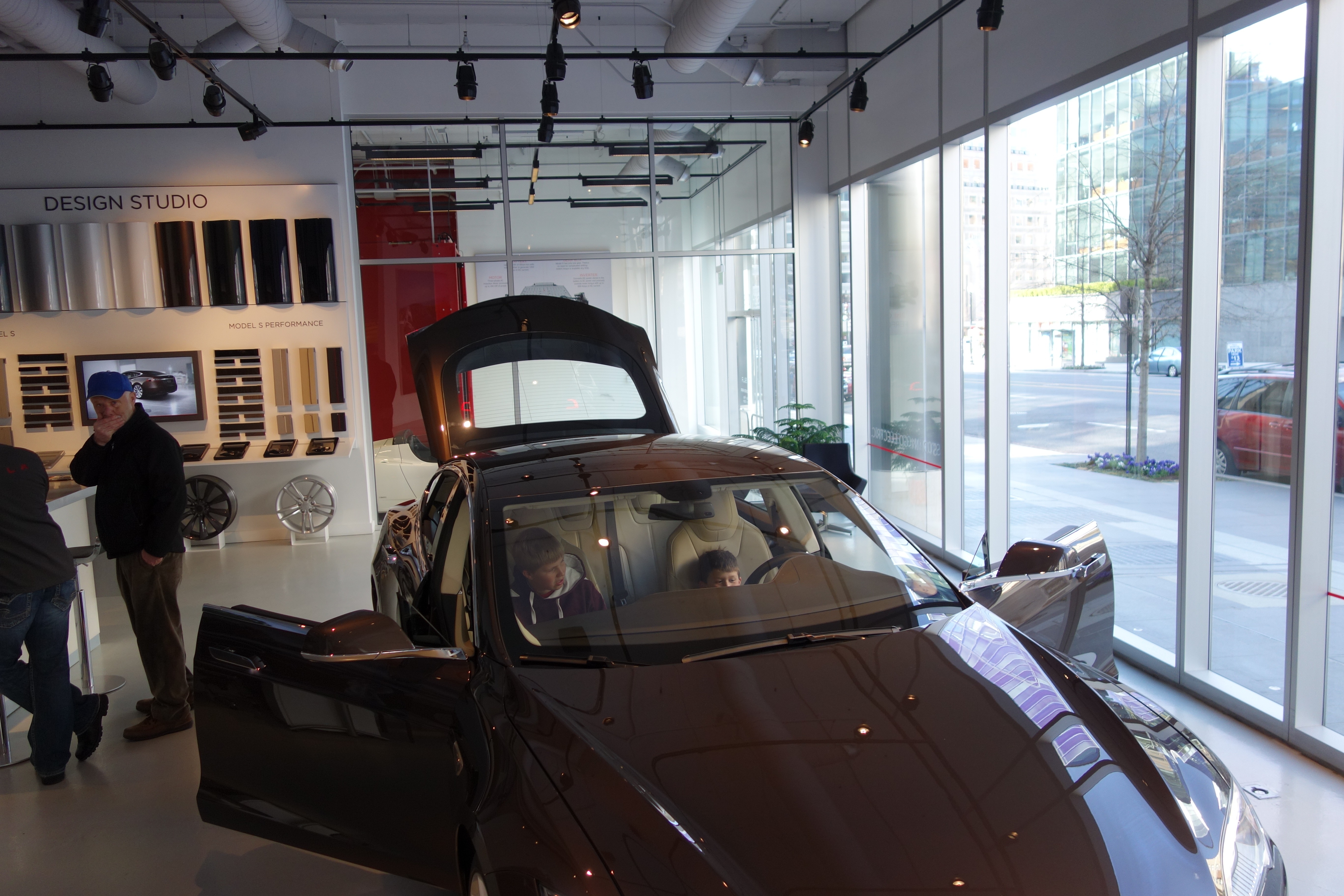 kids sitting in a Tesla
